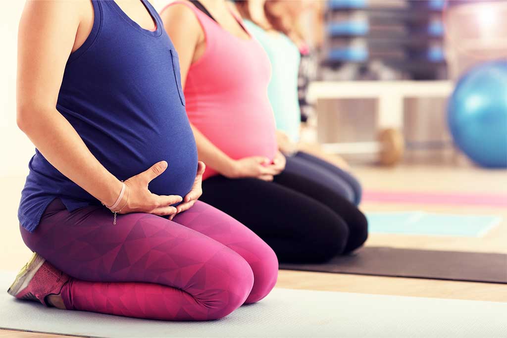 Pregnant woman in yoga class