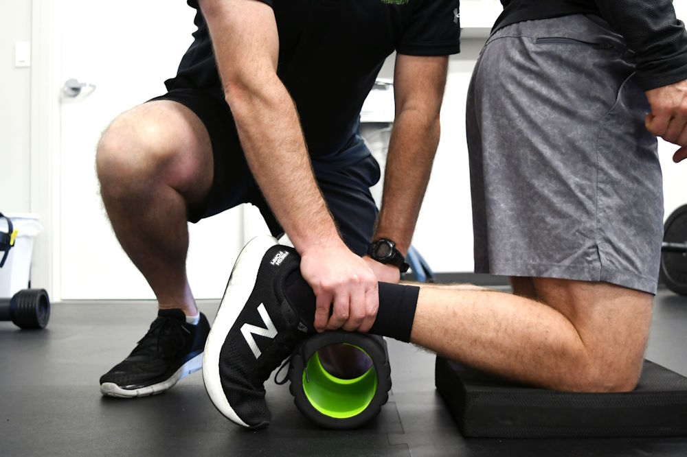 Using a roller for ankle rehab after injury